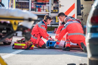 Medical personel securing wounded in the street.